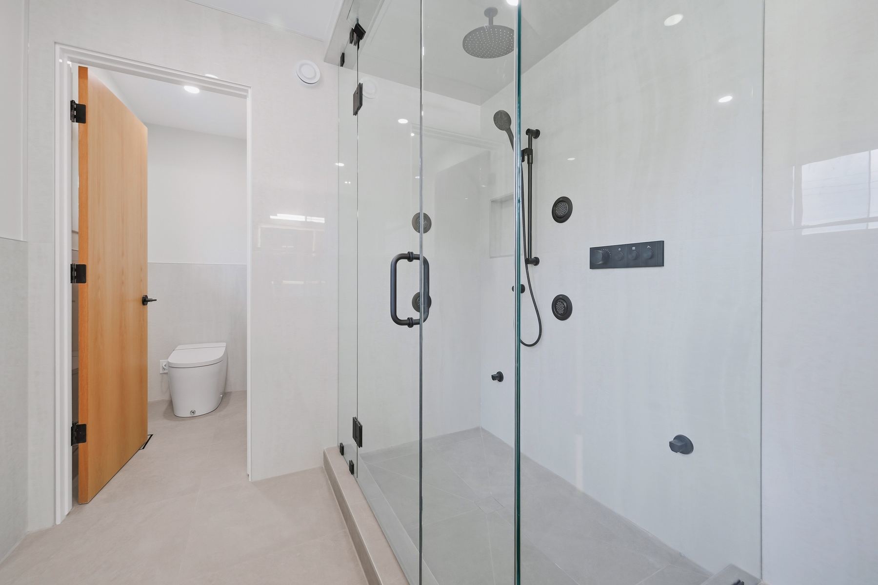 Steam shower with body sprayers and rainfall head