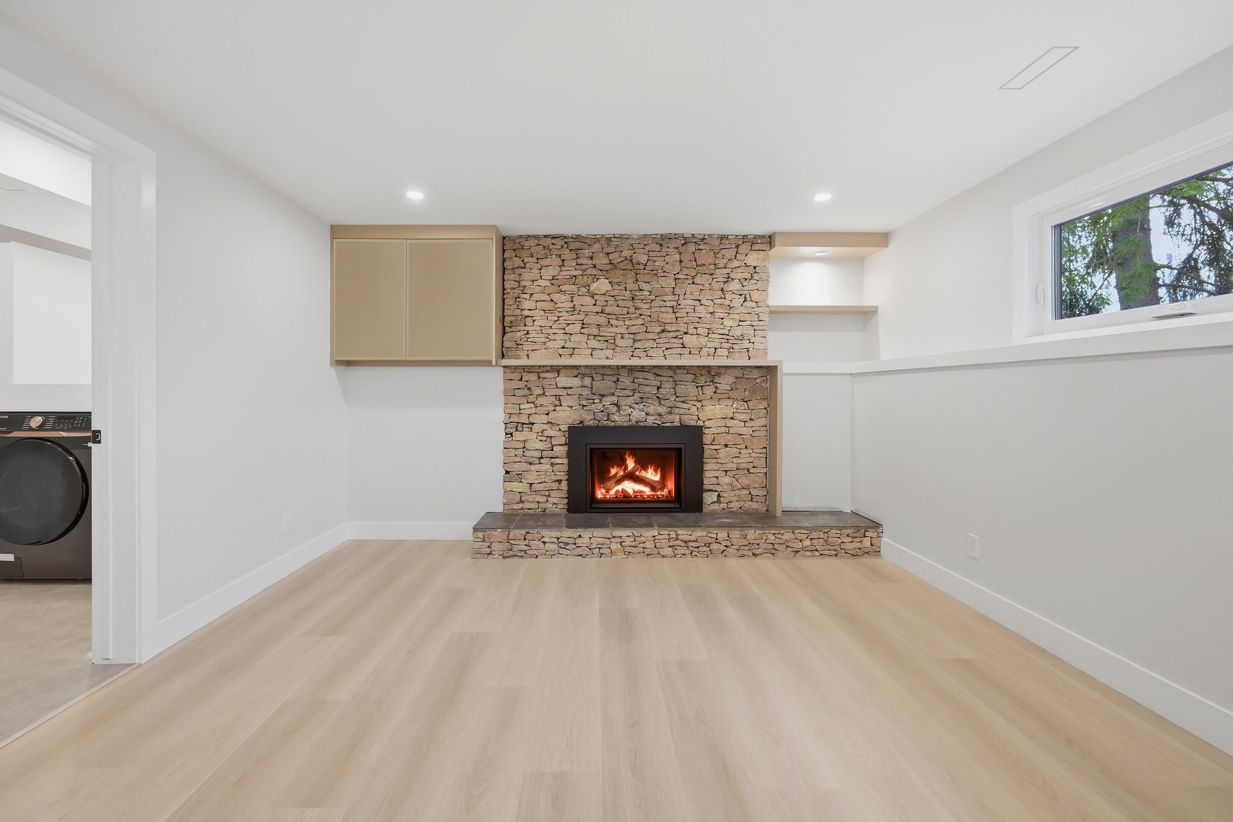 Recreation room — stone fireplace, fire lit