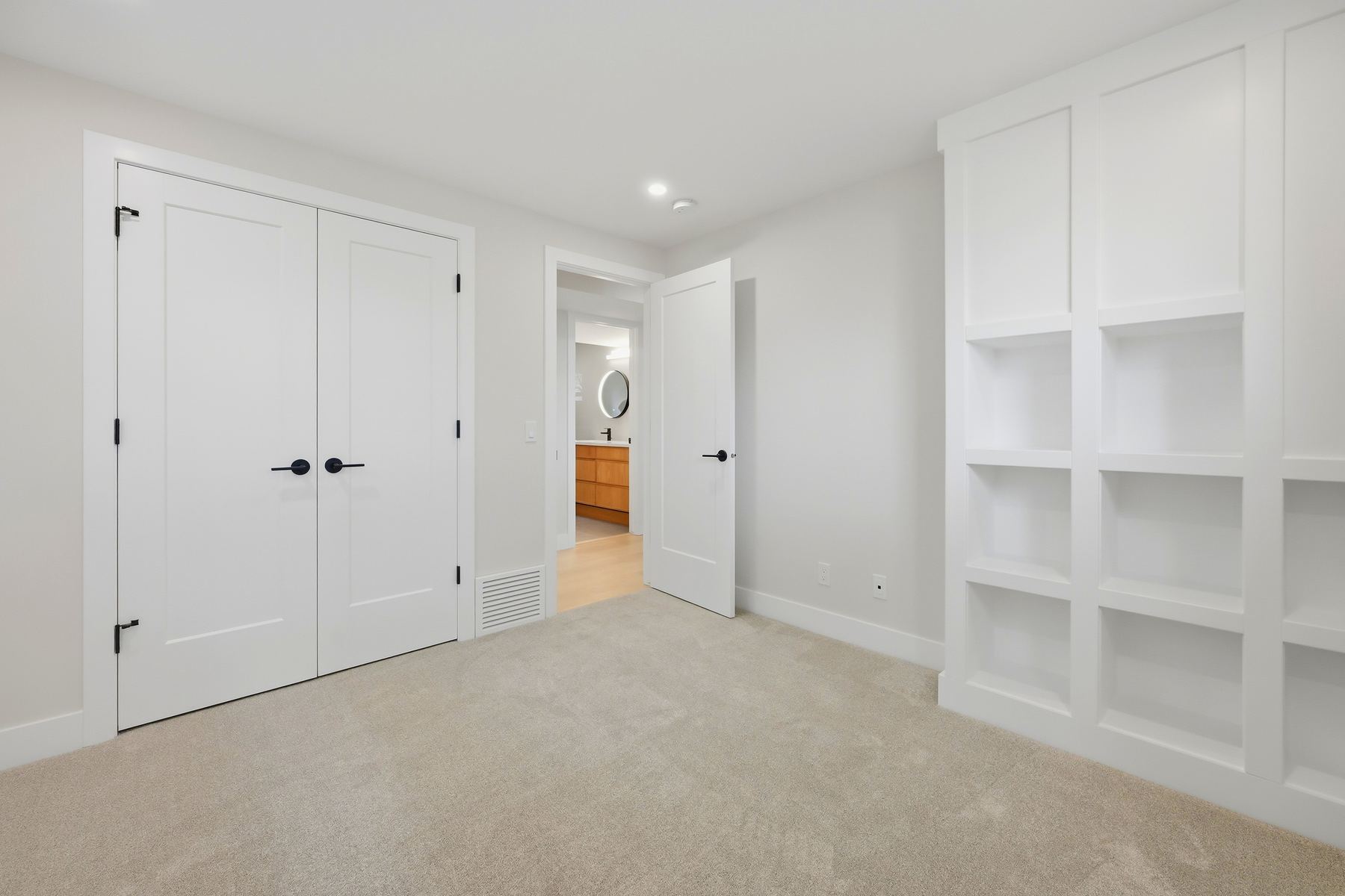 Lower-level bedroom with shelving