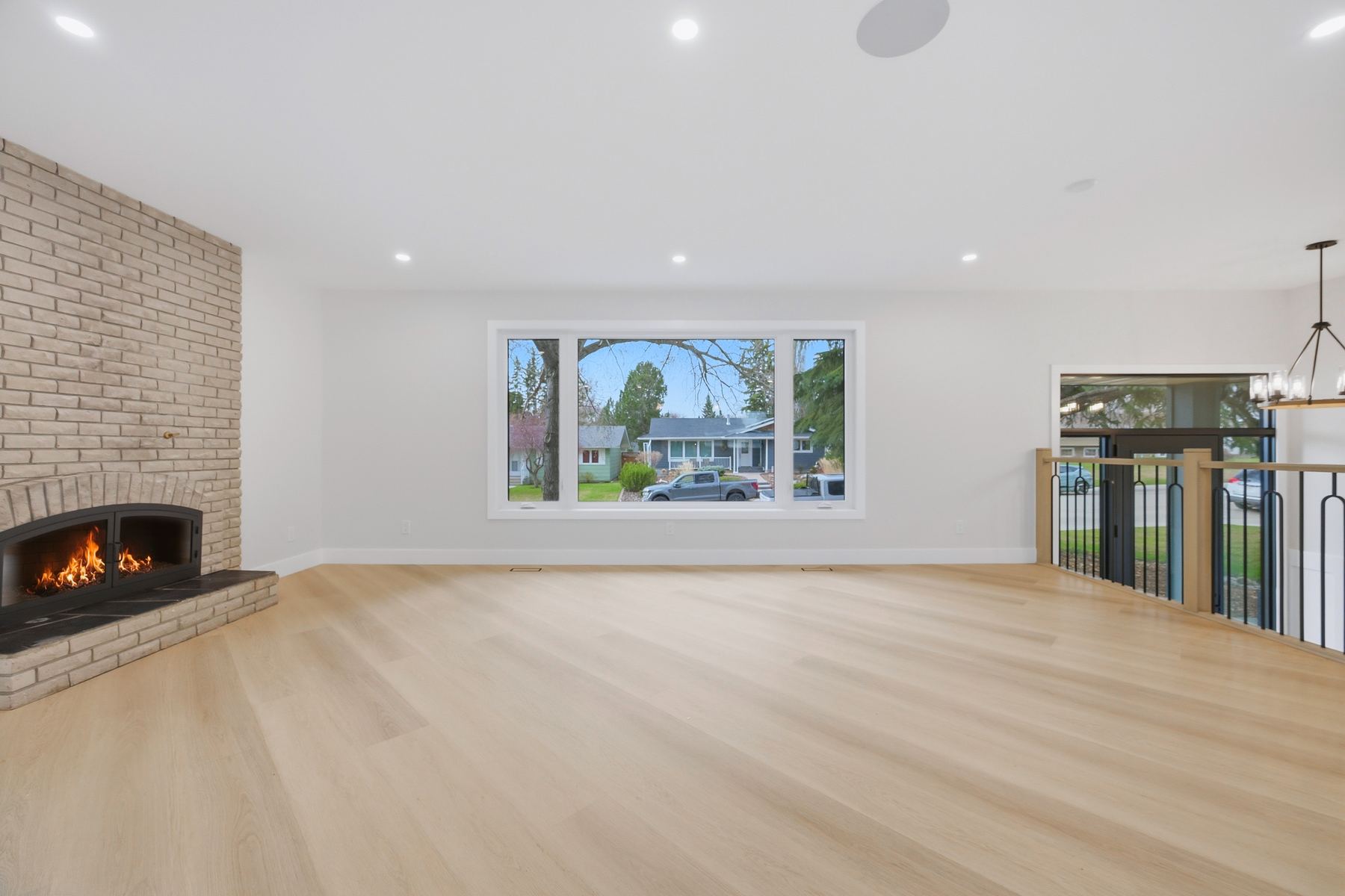 Living room — brick fireplace, fire lit