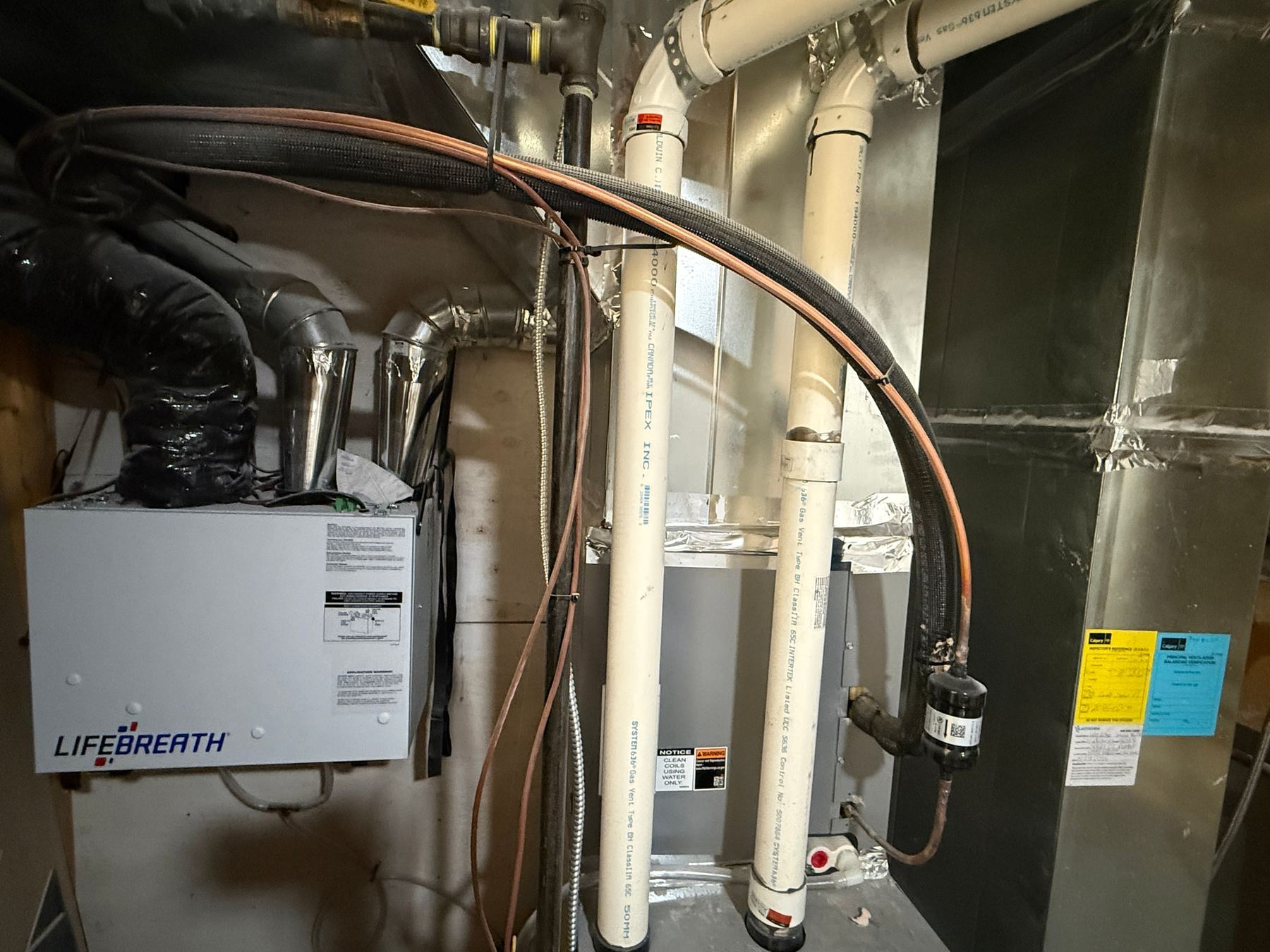 Mechanical room — high-efficiency furnace, HRV, copper plumbing